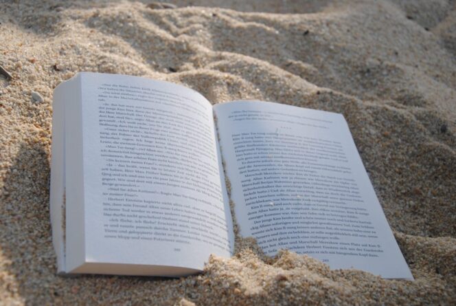white-book-on-sand-during-daytime-159597
